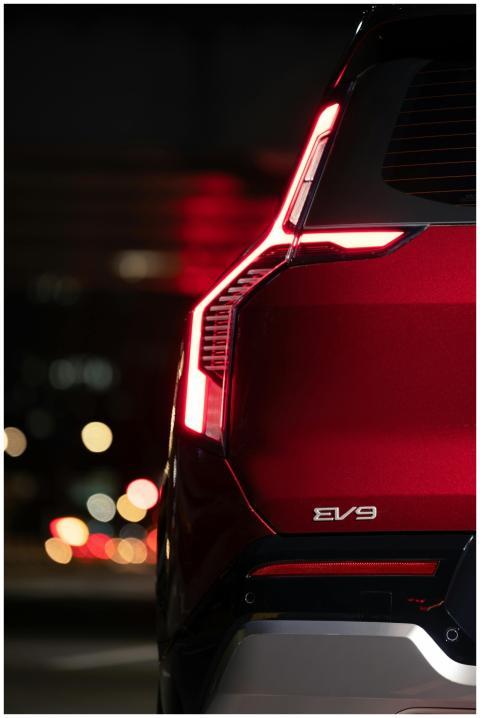 Modern EV9 SUV with sleek red design and illuminat