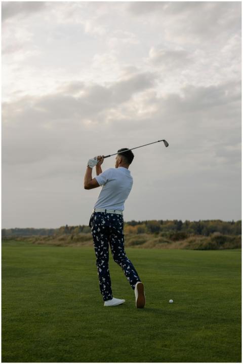 Back view of a man swinging a golf club on a golf
