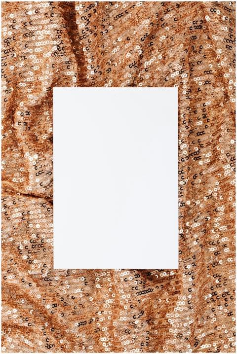 A blank white card framed by shimmering gold sequi