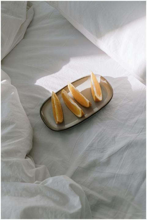 A high-angle view of sliced oranges on a ceramic p