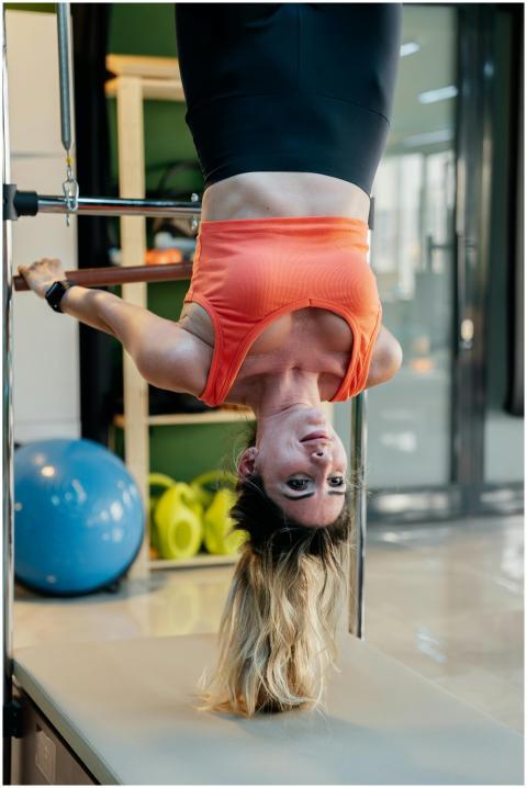 Adult woman performing an upside down pilates exer