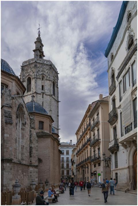 A bustling street scene in Valencia featuring the