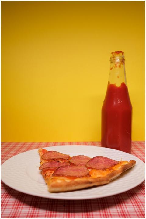 Slice of pizza placed on plate served on table wit