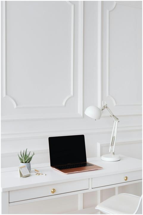 Modern minimalist desk setup featuring a laptop an