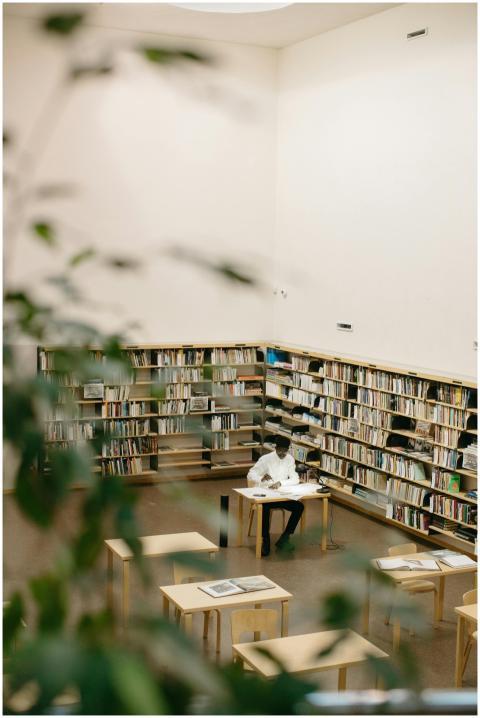 Adult man studying at a desk in a bright modern li