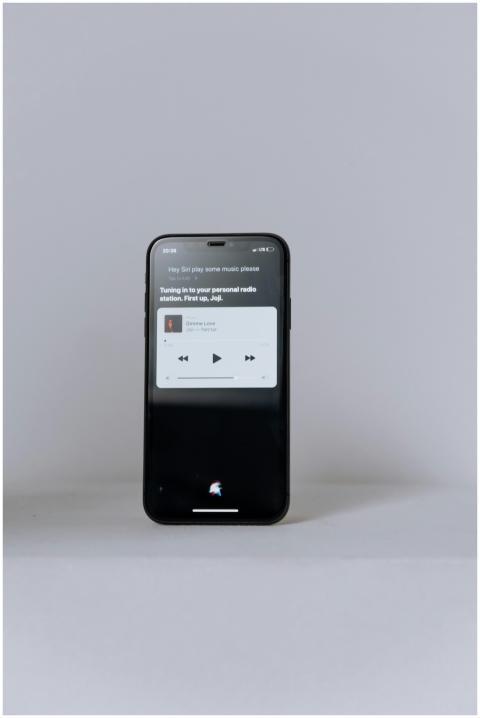 A smartphone showcasing a music app on a clean, mi