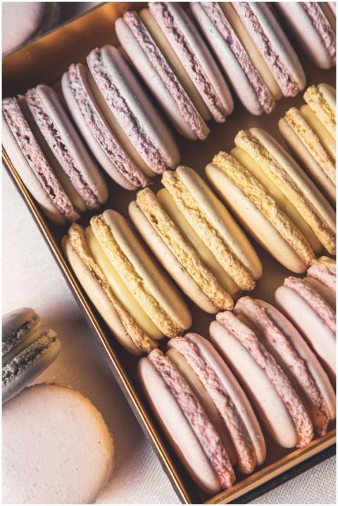 Tasty assorted macarons neatly stacked in a box, p