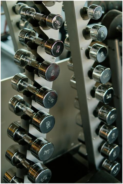 Close-up of chrome dumbbells neatly organized on a