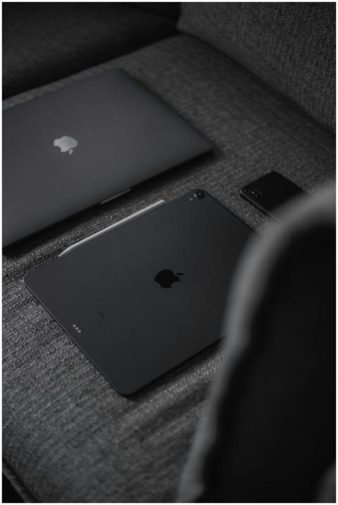 A sleek monochrome arrangement of laptop, tablet,