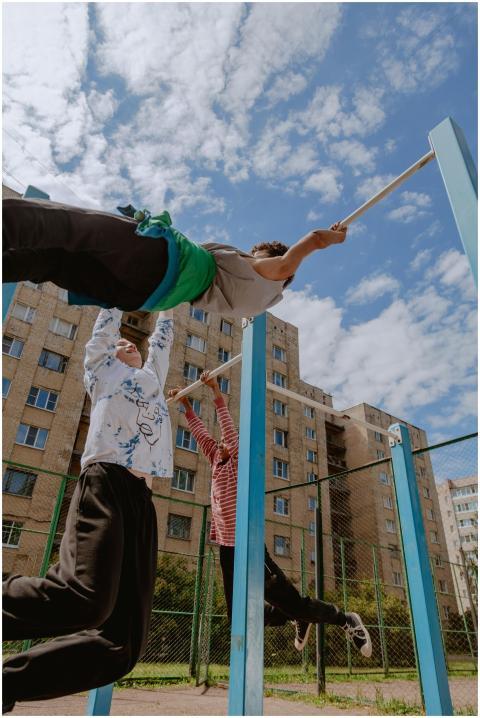 Teen boys enjoy a sunny day on the playground, han