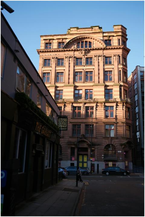 A classic historic building basks in sunset light