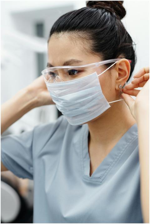Asian woman healthcare professional adjusting face