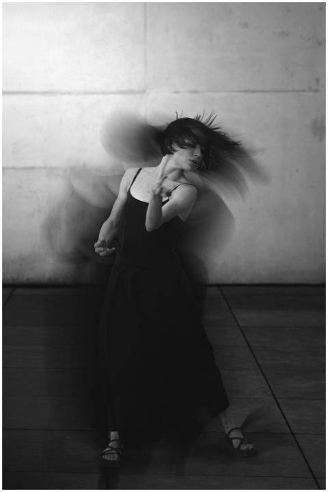 Dynamic black and white photo of a woman dancing w