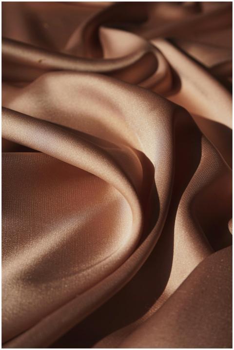 Close-up of luxurious crumpled brown silk cloth sh