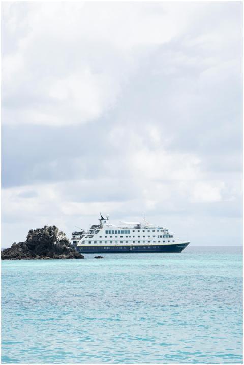 A cruise ship navigates the tranquil waters near t