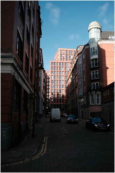City street view with modern buildings and vehicle