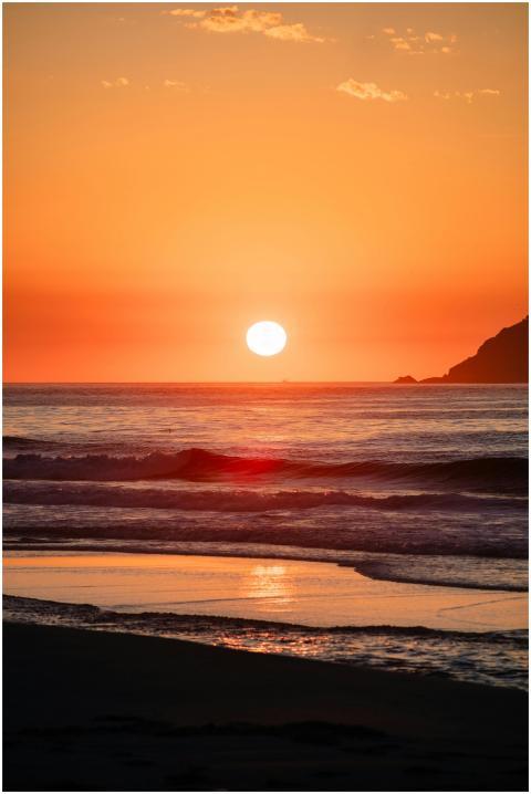 Coastal Sunset Over Silhouetted
