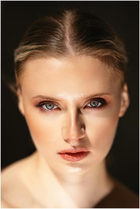 A striking headshot of a female model captured in