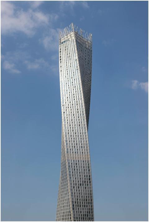 Cayan Tower rises against a clear blue sky in Duba