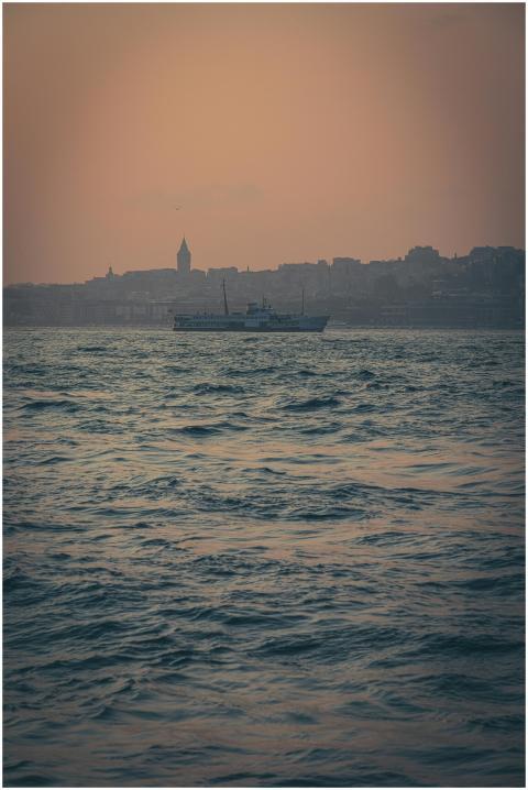 A serene view of a boat on the water against Istan