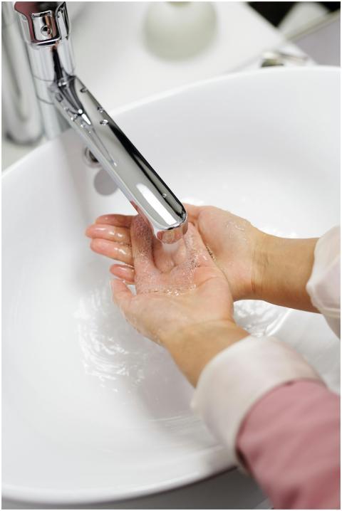 Close-up of hands washing under running water in a