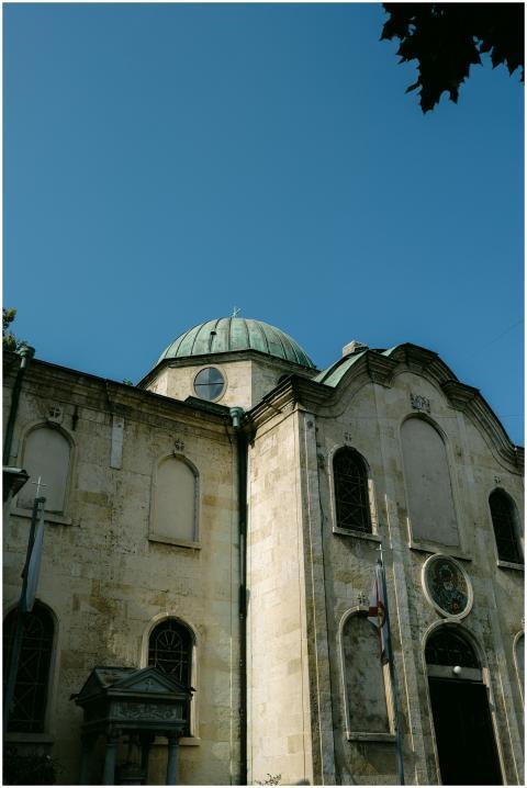 Sunny view of a historic church with classical arc