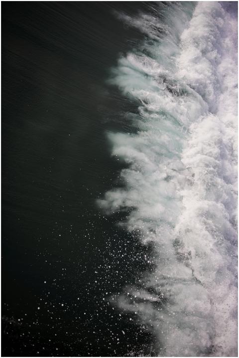 Photograph of a powerful ocean wave crashing, crea