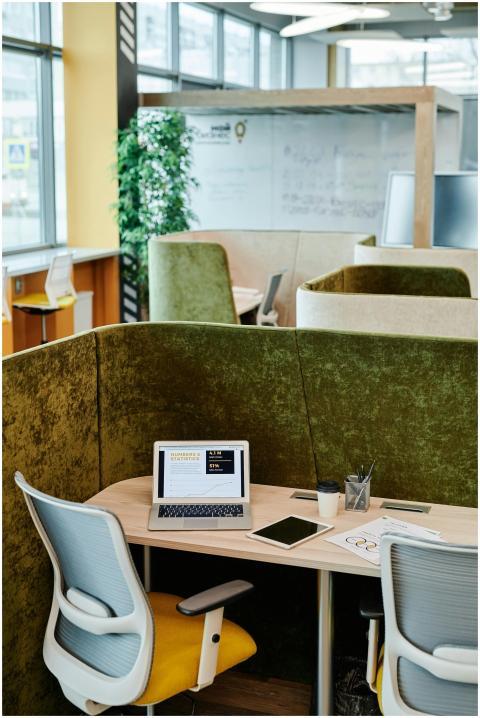 Cozy modern office workspace with a laptop, tablet