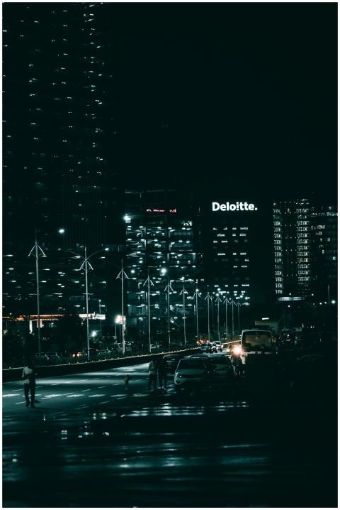 A vibrant night cityscape featuring tall skyscrape