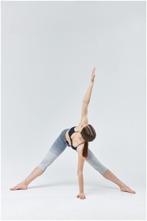 Woman in athletic wear practicing yoga, showcasing