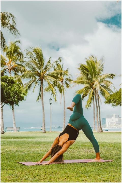 Woman practicing yoga outdoors on a sunny day with