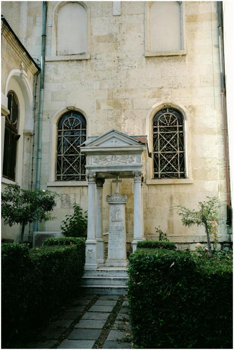 Elegant stone monument set against an ornate histo
