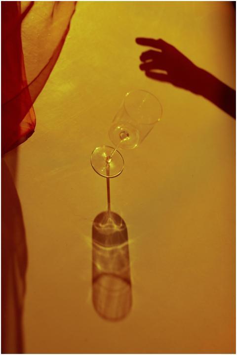 Elegant cast shadow of wineglass with hand silhoue