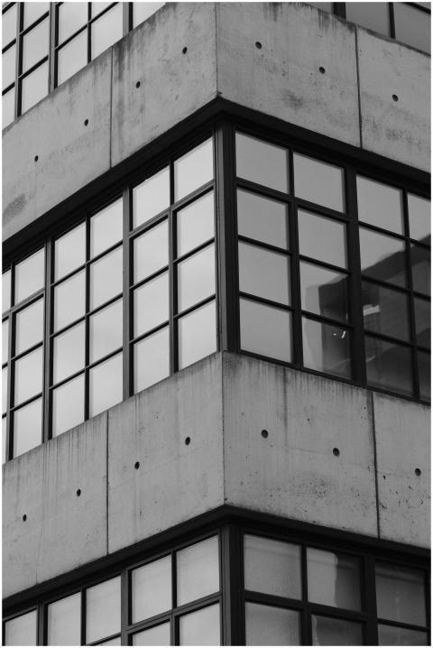 Monochrome photo of a modern glass and concrete bu