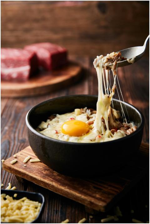 A delicious melted cheese and egg bowl on a wooden