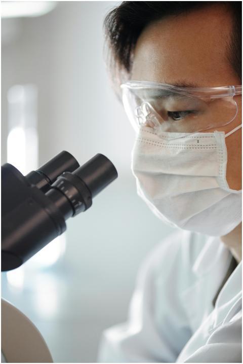 Close-up of a researcher examining samples through