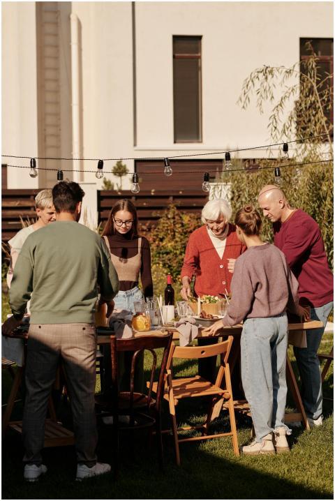 Family enjoying outdoor meal and drinks in the gar