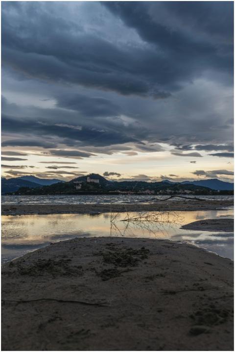 Twilight over a riverbank with dramatic clouds ref