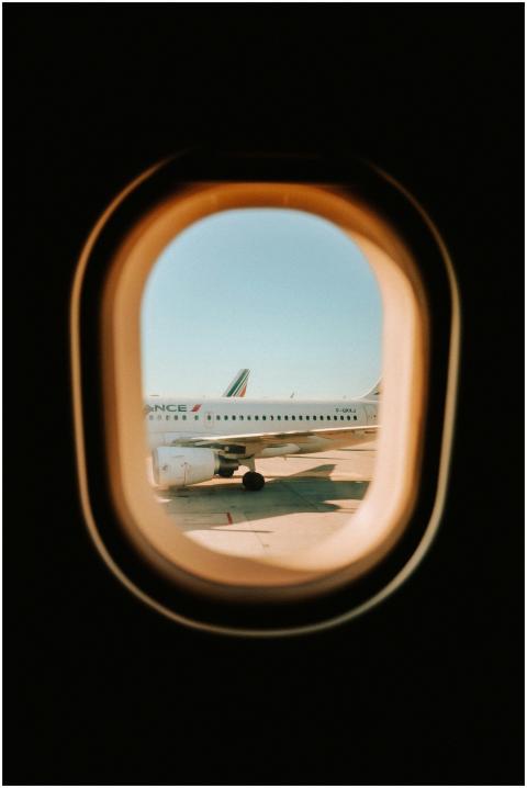 Airplane captured through a window seat during tak