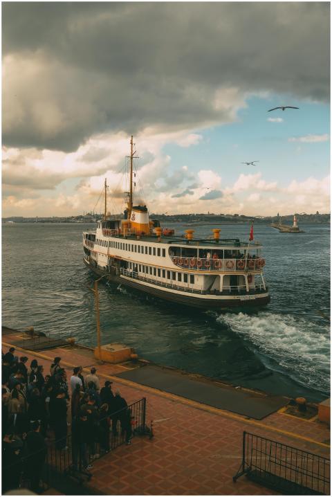 A ferry sails away from the marina under a dramati