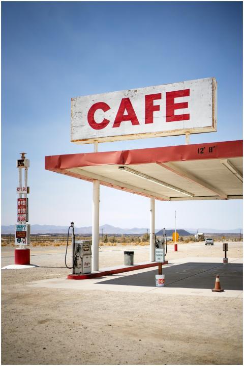 Desert gas station with a vintage cafe sign, empty
