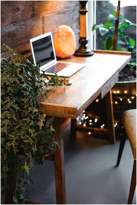 A cozy home office setup featuring a laptop, salt