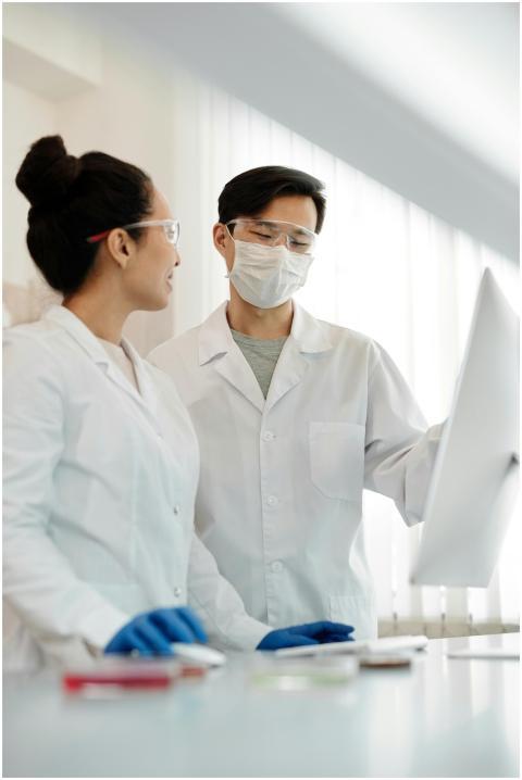 Two scientists discussing research results in a la