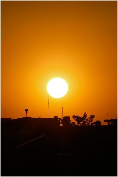 Silhouetted buildings under a vibrant sunset in Va