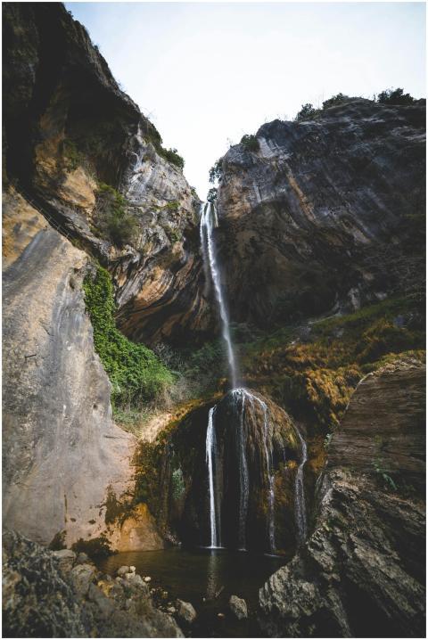 A stunning waterfall flowing down a rocky mountain