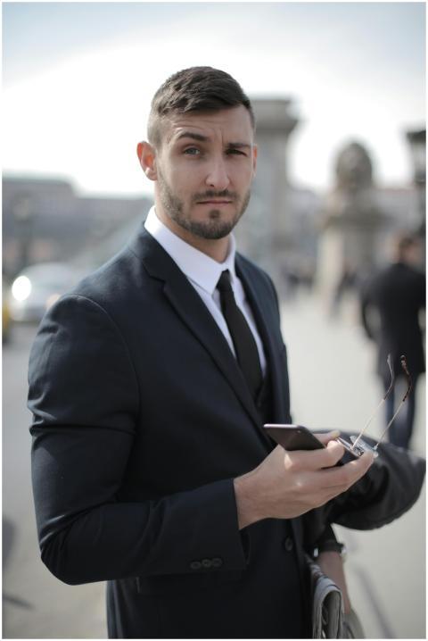 Portrait of a confident businessman holding a smar