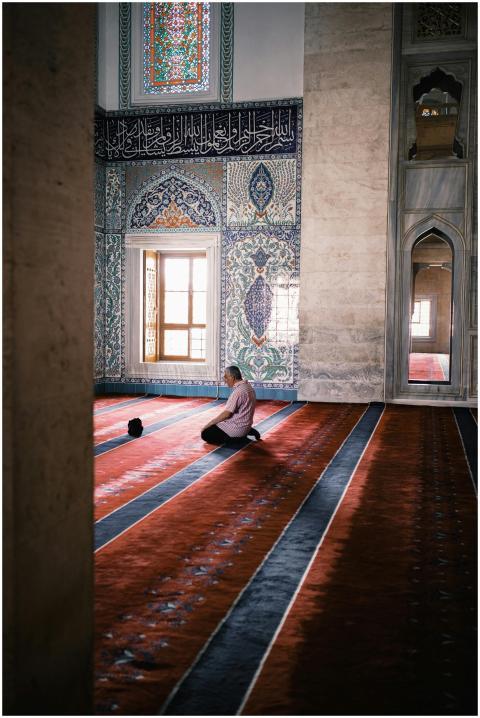 A serene moment of a man praying inside the Kocate