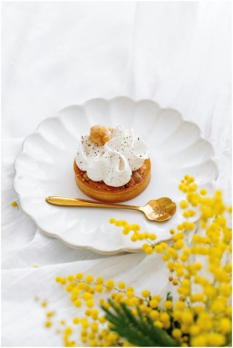 Elegant dessert with whipped cream and a golden sp