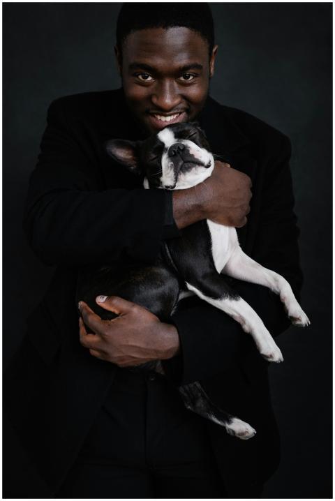 Good looking black male in black apparel on black