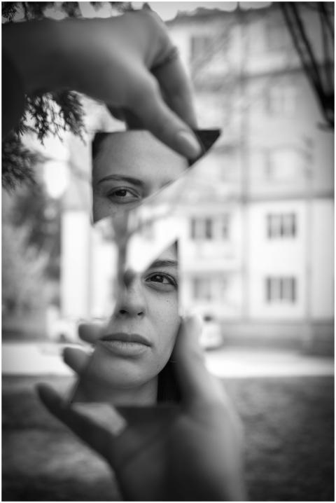 Artistic black and white portrait through broken m